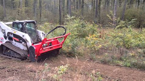 skid steer pulling logs|bobcat logging forest.